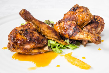 A delicious dish. Chicken ham fried on a grill, sauce and herbs. Horizontal frame
