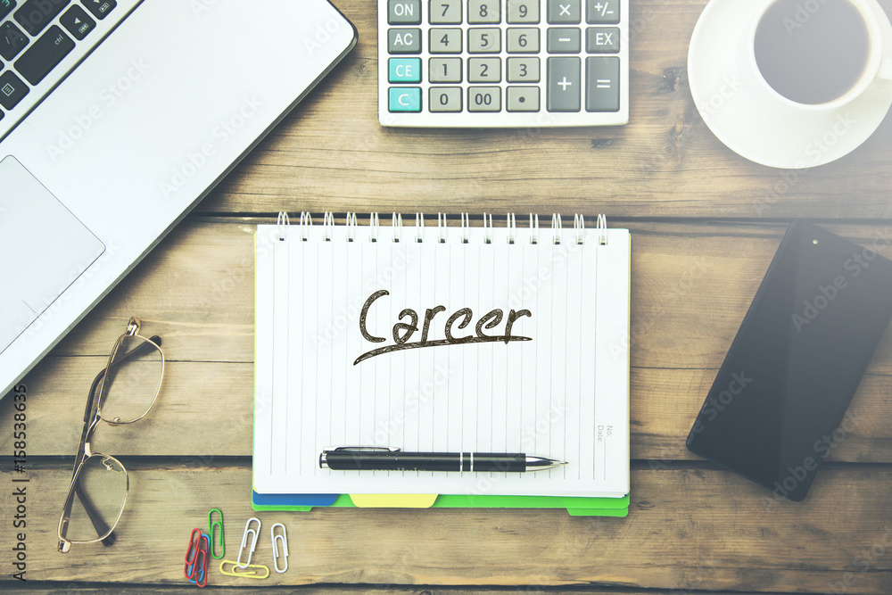 Aufkleber career text on notepad with keyboard on working table