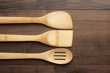 different wooden kitchen tools on the table with copy space