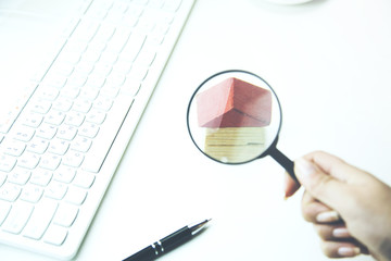 Toy small house through the magnifying glass