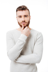 Vertical portrait of young handsome man looking at  the camera over white background. Attractive...