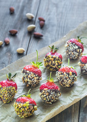 Fresh strawberries covered with dark chocolate and nuts