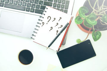 Question mark on notepad on keyboard