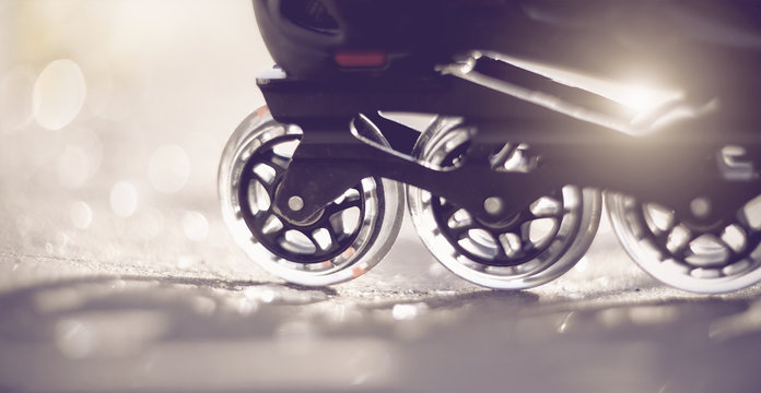 Road and wheels of roller skates closeup