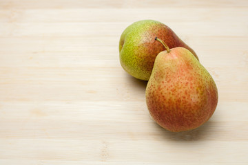 Two pear fruits on wooden background