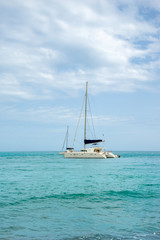 Fototapeta na wymiar White sailing catamarans in a turquoise sea