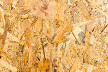 Close up pressed wooden panel background, texture of oriented strand board - OSB wood