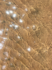 Shimmering water on sand