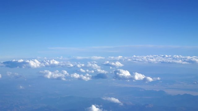 Aerial shot above the clouds of mountains in 4K