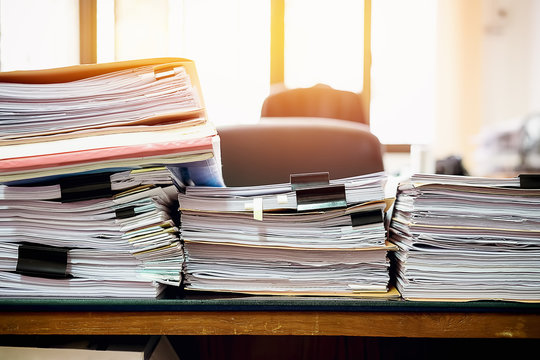 Close up Pile of unfinished business documents on office desk, Stack of business paper