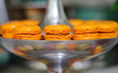 Colorful round macaron cookies on a silver pedestal