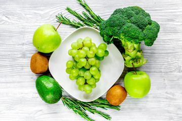 green fresh food for fitness diet on gray wooden table background top view