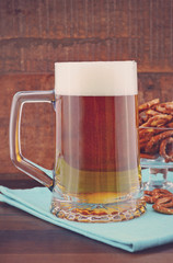 Glass of beer in stein with mini pretzels