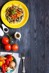 Delicious pasta with fresh vegetables and cheese, on a wooden background .