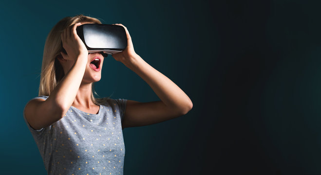 Young woman using virtual reality headset