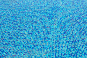 Blue water with mosaic bottom in pool