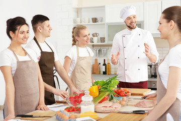 Male chef and group of people at cooking classes