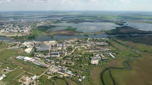 Unusual shot of of Kherson city embankment and curvy line of the Dnipro river with small lakes and patches of greenary in the background. The skyscape and landscape look great and gorgeous.