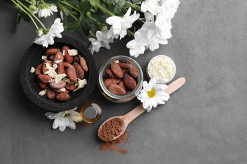 Beautiful composition with cocoa butter lotion and ingredients on table