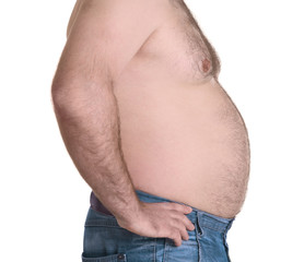 Naklejka premium Adult man in jeans on white background. Weight loss concept