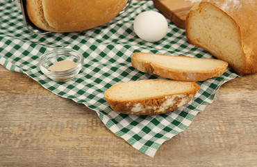 Loaves baked in bread machine and ingredients on napkin