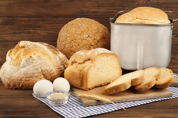 Different bread and ingredients on wooden table
