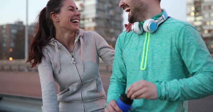 Beautiful couple talking after fitness exercising and jogging
