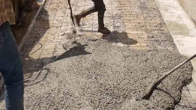 man plasterer concrete working at floor of home construction buil.