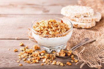 Muesli and yogurt in a glass on a table. Selective focus. Copy space for text