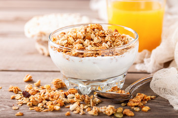 Muesli and yogurt in a glass on a table. Selective focus. Copy space for text