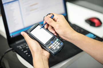 Hands holding portable barcode scanner © chawannoot