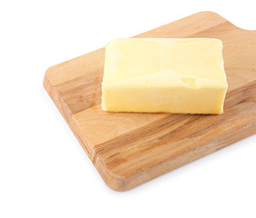 Wooden board with butter on white background, closeup