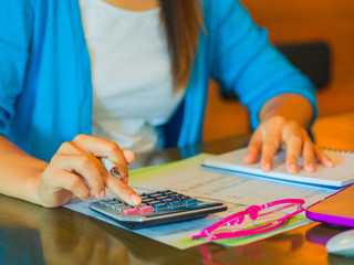 woman working with calculator, business document and laptop computer notebook