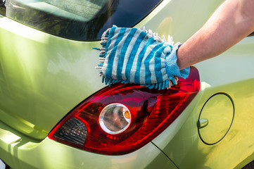 Man washing his car - car washing and car cleaning concept