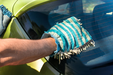 Man washing his car - car washing and car cleaning concept