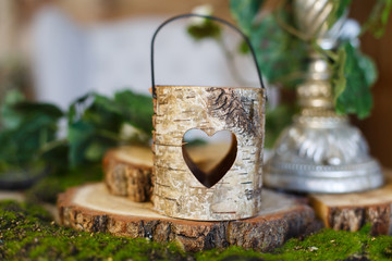 Wooden lantern for candle with hole in form of heart in rustic style