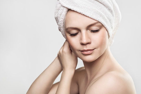 Beautiful Girl After Bath Touching Her Face. Skincare. Beauty lady with towel on her headtouching.