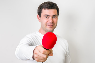 Portrait of male reporter with red microphone