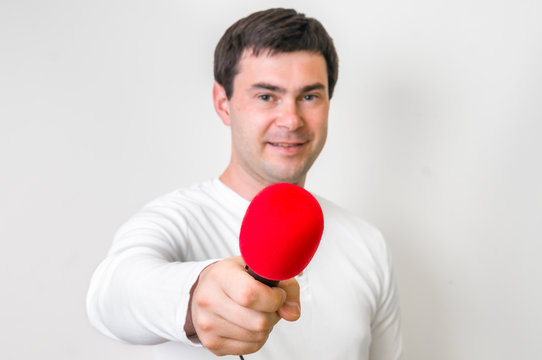 Portrait Of Male Reporter With Red Microphone