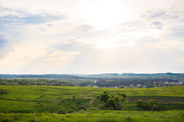 Fototapeta premium Summer or spring landscape with green hills or mountains and trees