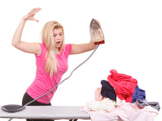 Woman holding iron about to do ironing