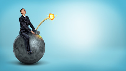 A small businessman riding a big round bomb with a lit fuse on blue background.