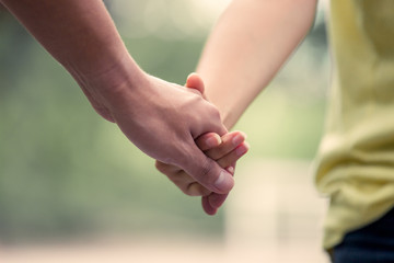 Young love couple holding hands and walk together in vintage color tone