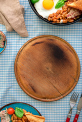 Kitchen board with English breakfast on the table