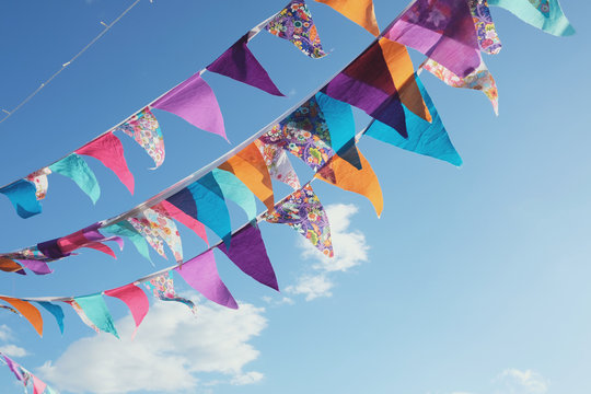Summer festive colorful bunting and blue sky, summer event celebration