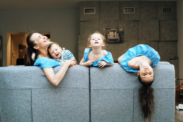 Mom, two daughters and a little son on the couch