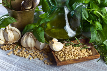 Ingredients for making pesto on a wooden table .