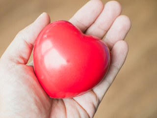 Red heart in hand to lovers.