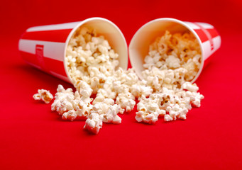 Popcorn in red and white cardboard box. Popcorn border isolated on white. Film. Fast food. Corn