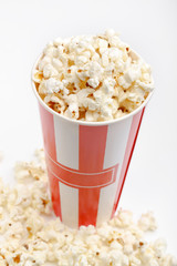 Popcorn in red and white cardboard box. Popcorn border isolated on white. Film. Fast food. Corn